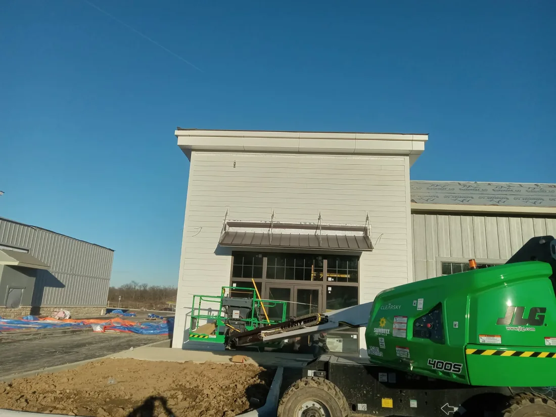 Commercial building exterior with a boom lift on site