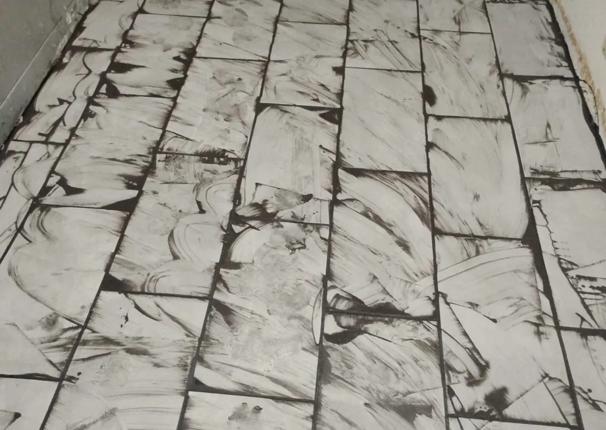 Large-format marble-look tile floor laid out across a room